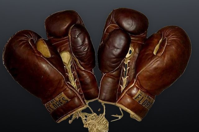 Two vintage FLORES glove pairs in brown and oxblood leather, laid side by side.