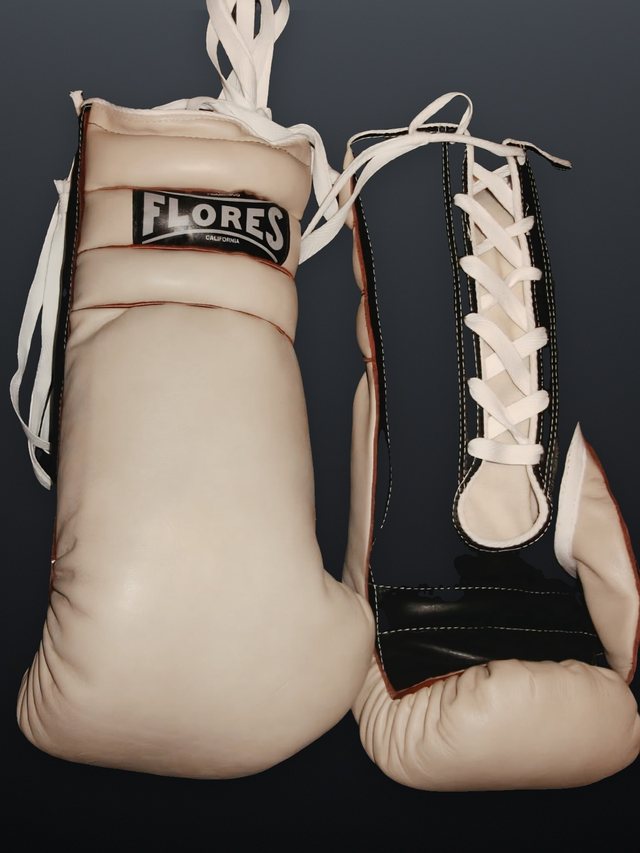 A FLORES pair in cream and black leather with oxblood piping and white cotton-twill laces.