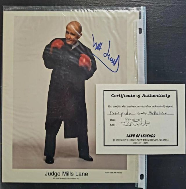 Signed photograph of the referee Judge Mills Lane, displayed with its certificate of authenticity.