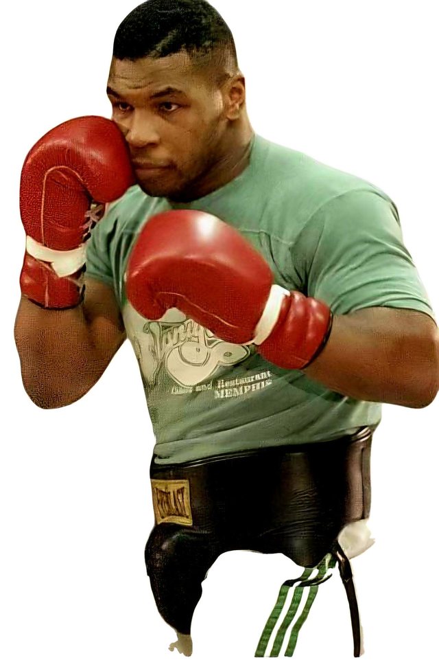 Mike Tyson in a training stance, gloves raised, from a period press feature.